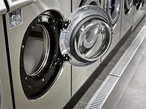 Commercial laundry equipment in apartment building laundry facility