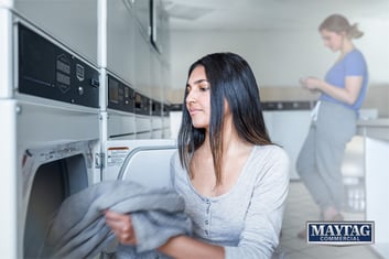 Woman in Apartment Maytag Commercial Laundry Room